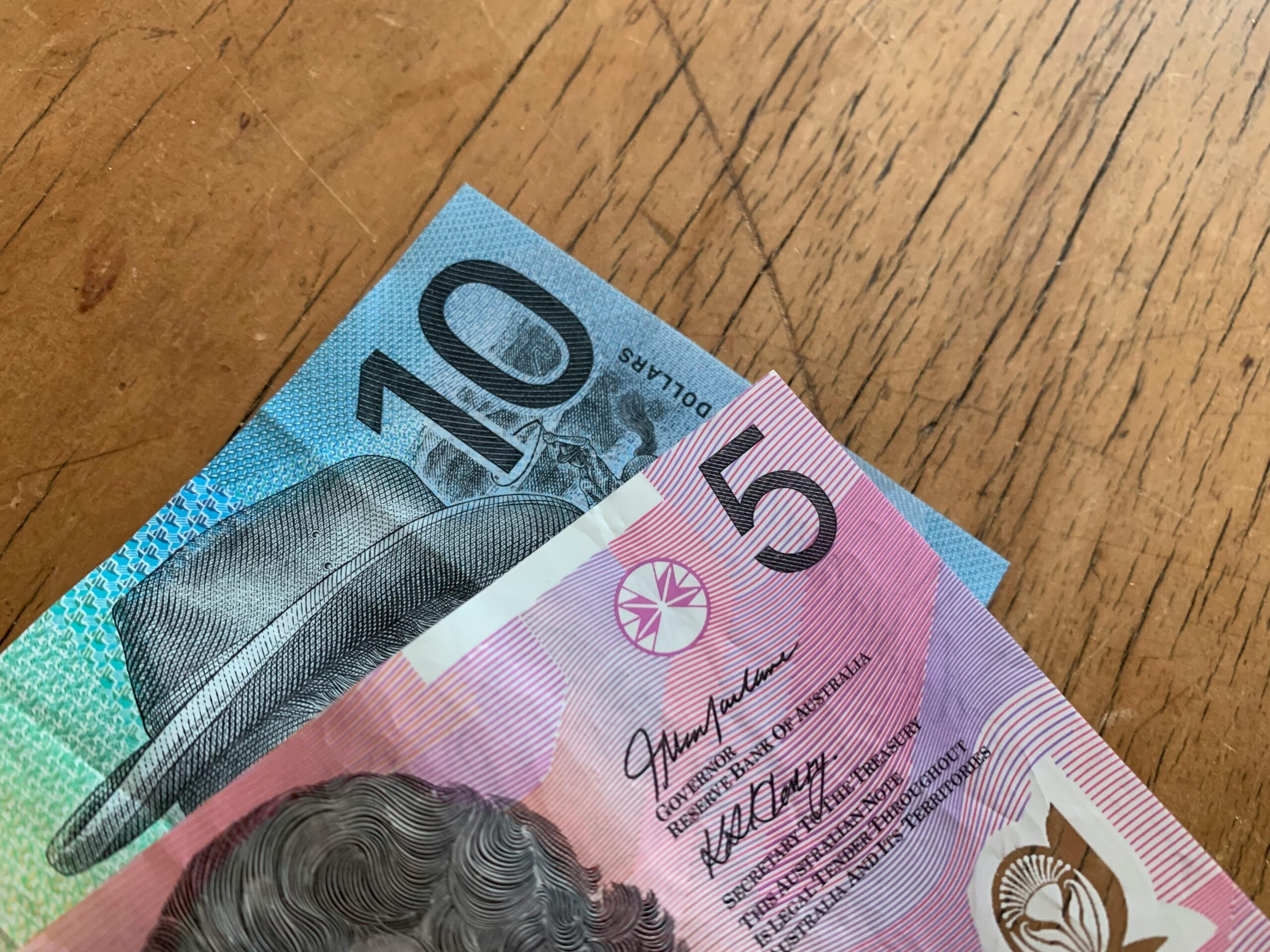 Canadian dollar banknotes and coins on table